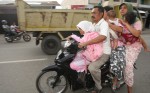 Six people ride on one motorbike as they move to higher ground following an earthquake off Banda Aceh 1. Six people ride on one motorbike as they move to higher ground following an earthquake off Banda Aceh